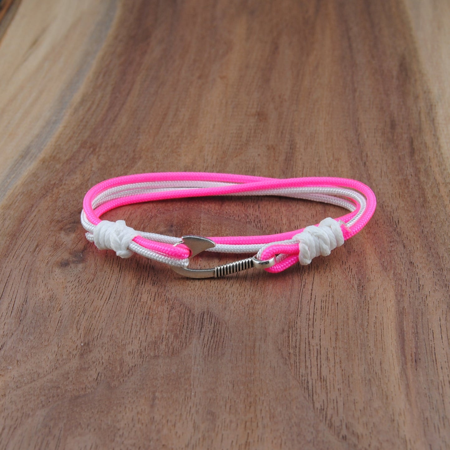 Pink and white bracelet on a wooden surface