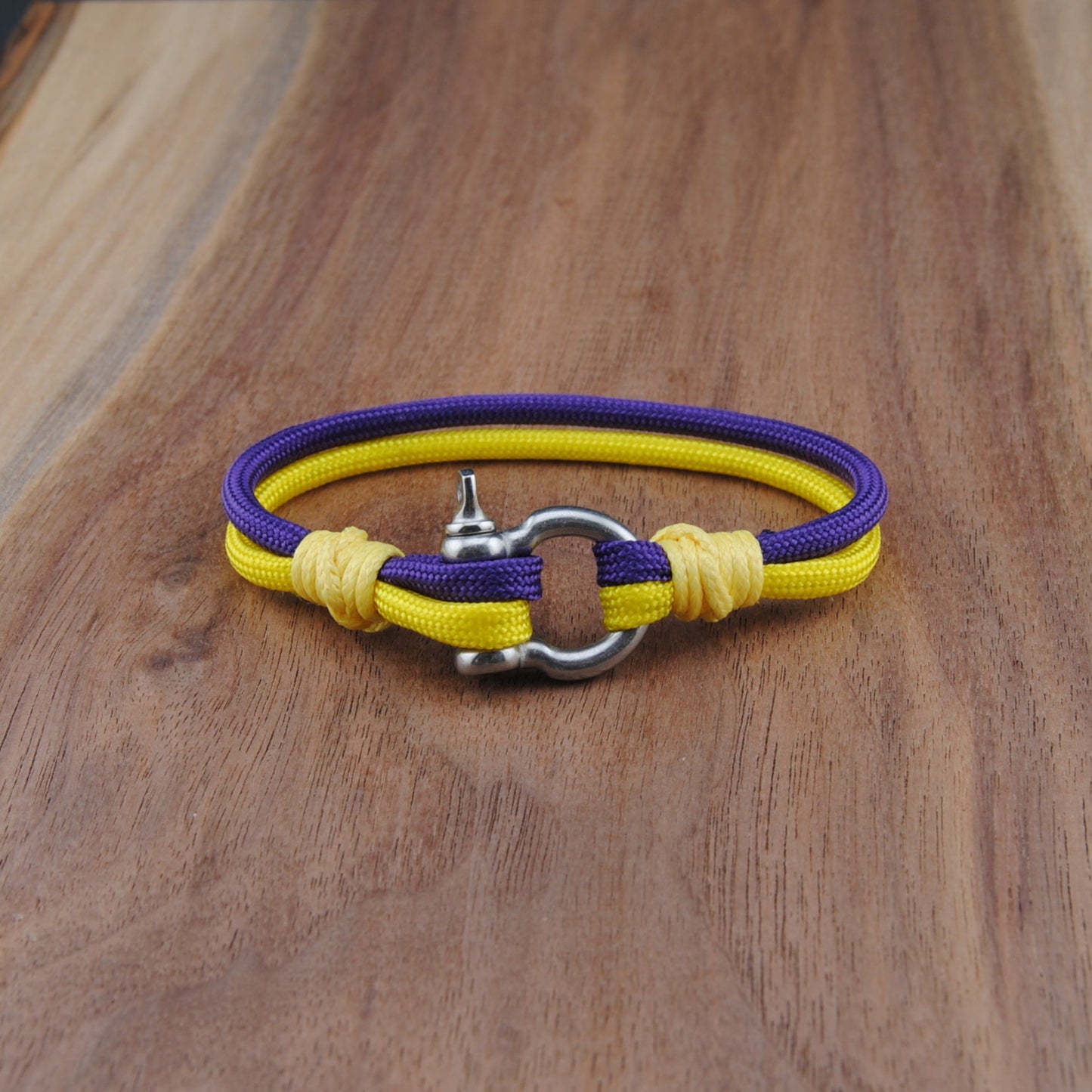 Yellow and purple bracelet on a wooden surface