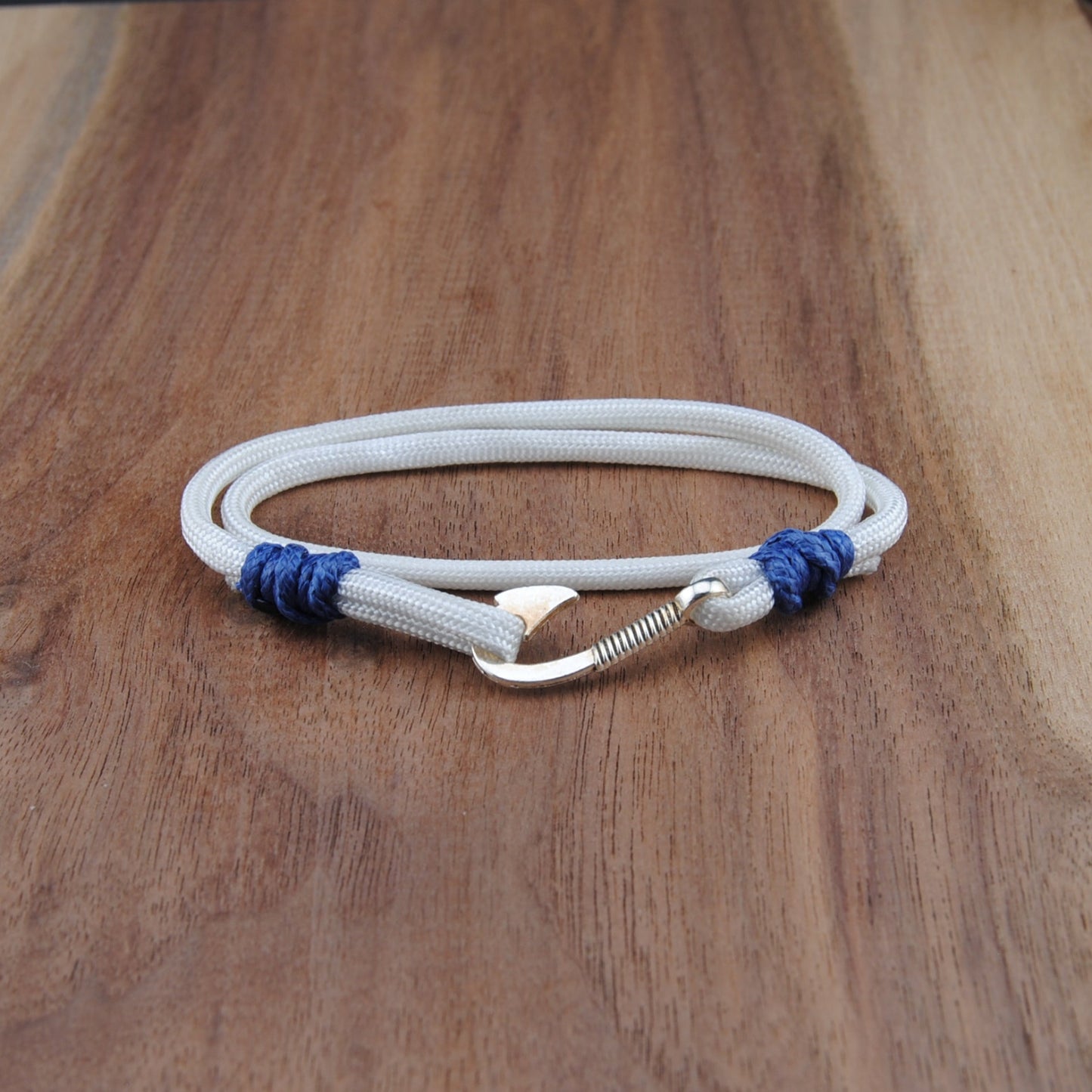 White bracelet with blue accents on a wooden surface
