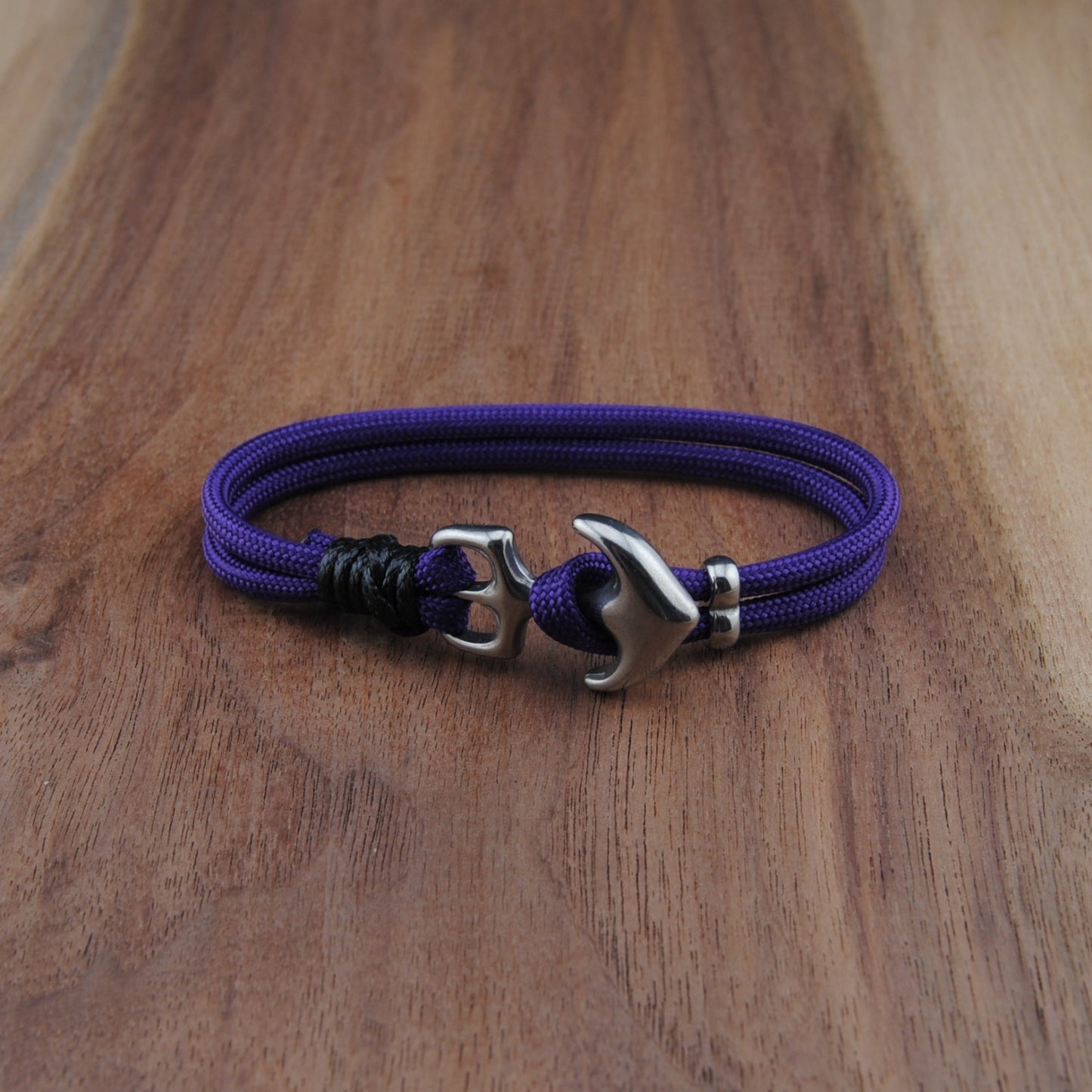 Purple bracelet with a silver clasp on a wooden surface