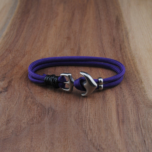 Purple bracelet with a silver clasp on a wooden surface