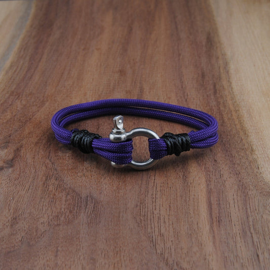 Purple bracelet with a silver clasp on a wooden surface