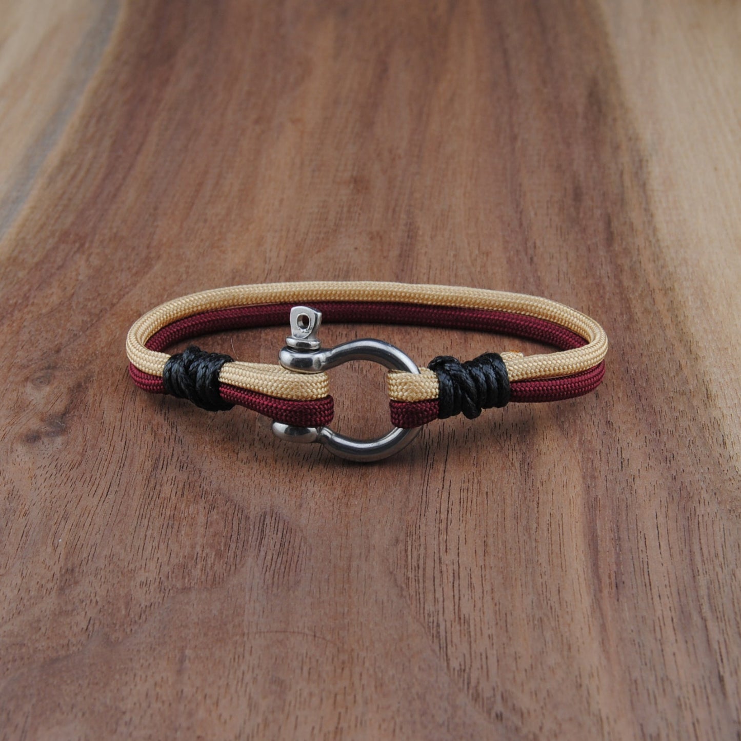 Bracelet with leather straps on a wooden surface