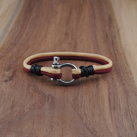Bracelet with leather straps on a wooden surface