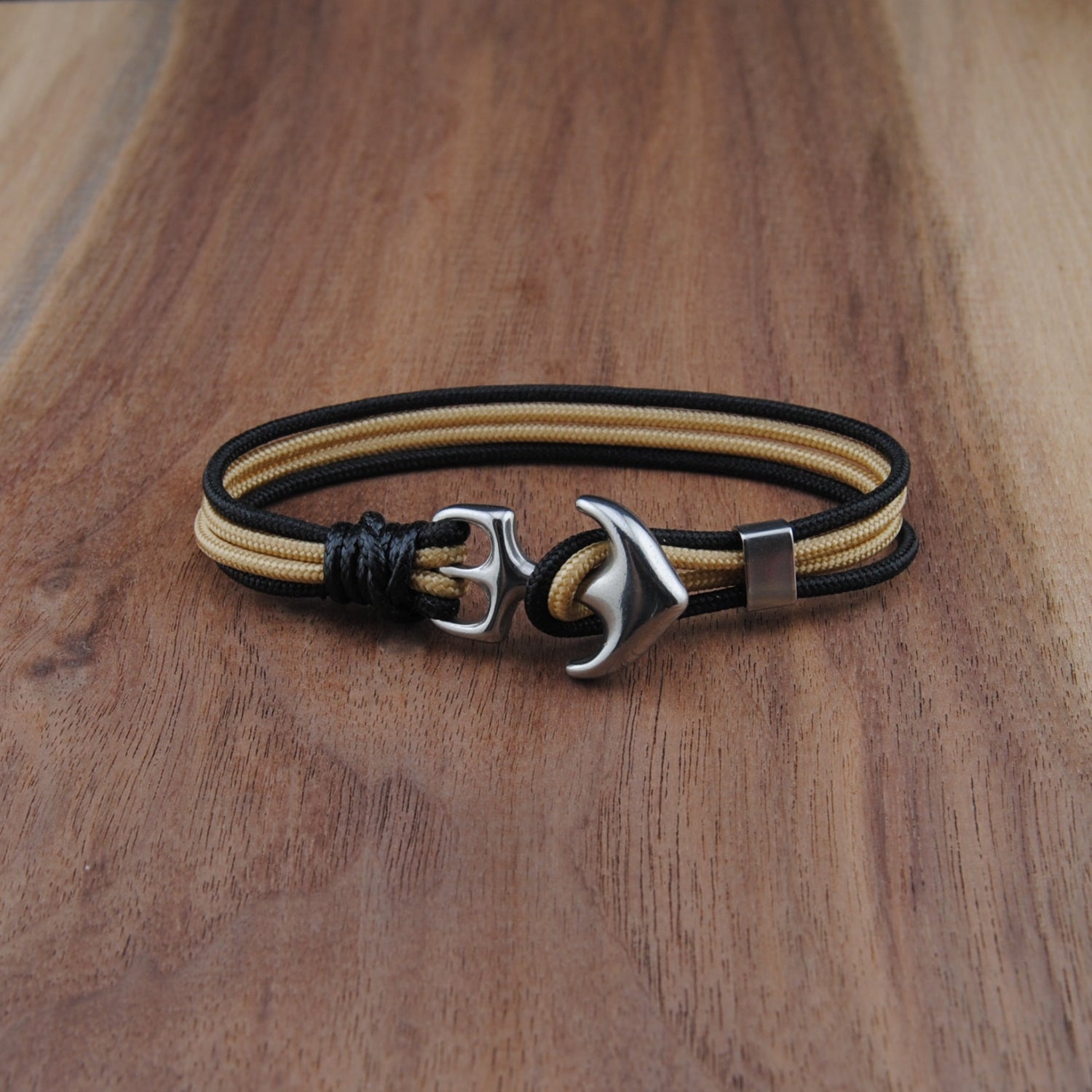 Bracelet with anchor charm on a wooden surface