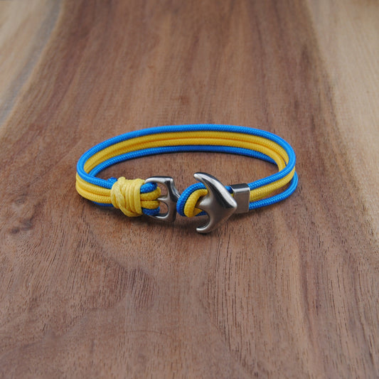 Yellow and blue bracelet with a silver clasp on a wooden surface