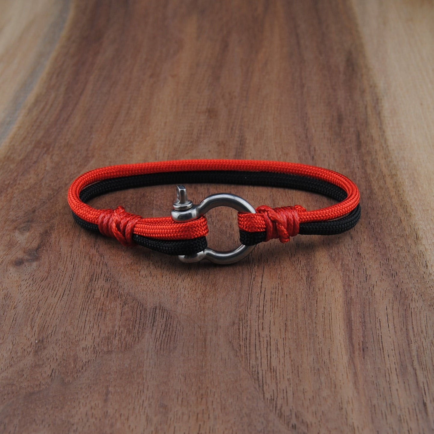 Red and black dog collar on a wooden surface