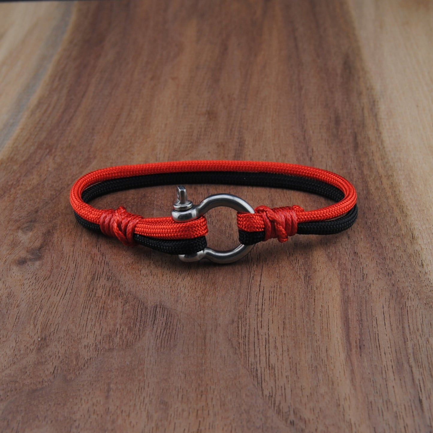 Red and black dog collar on a wooden surface