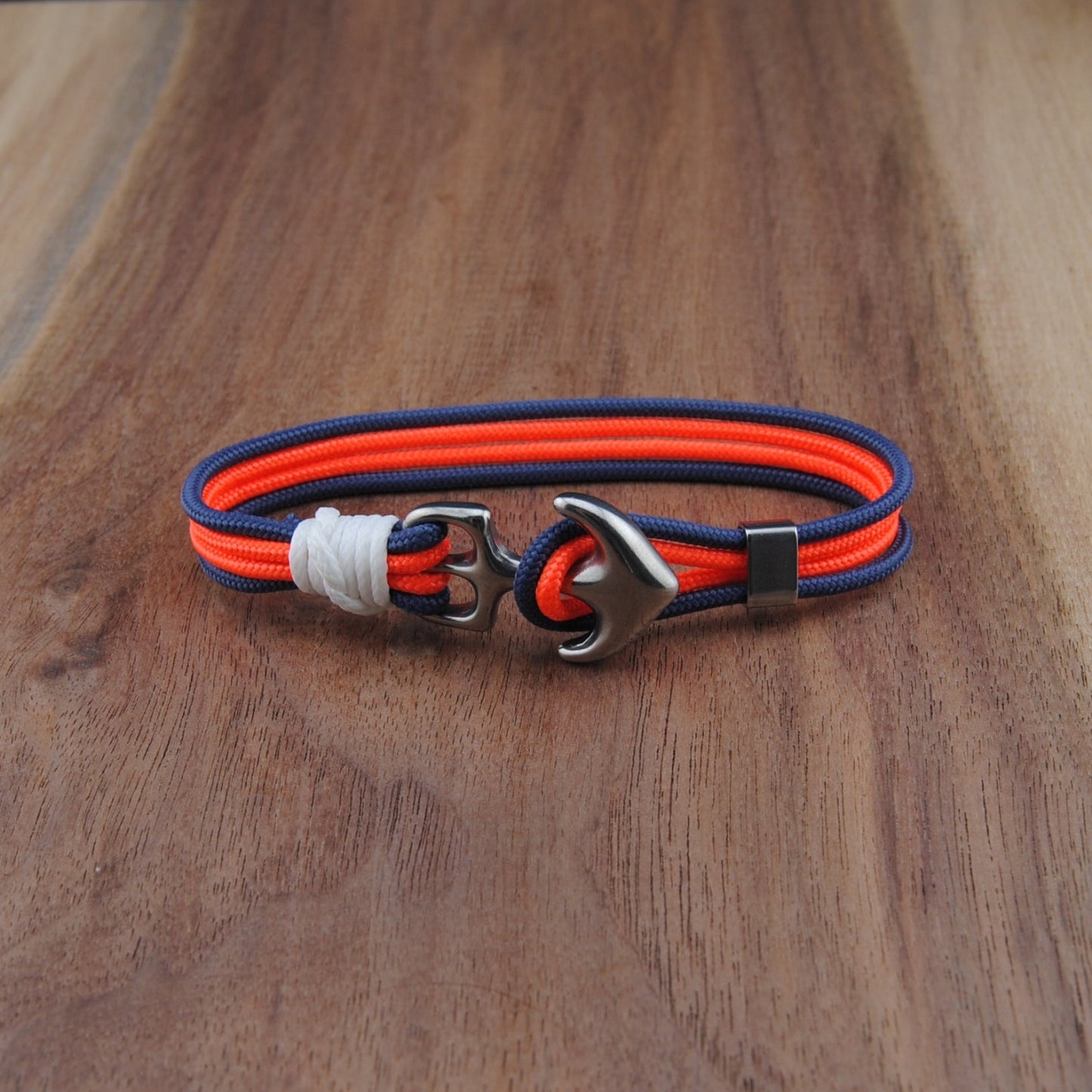 Bracelet with red and blue straps on a wooden surface