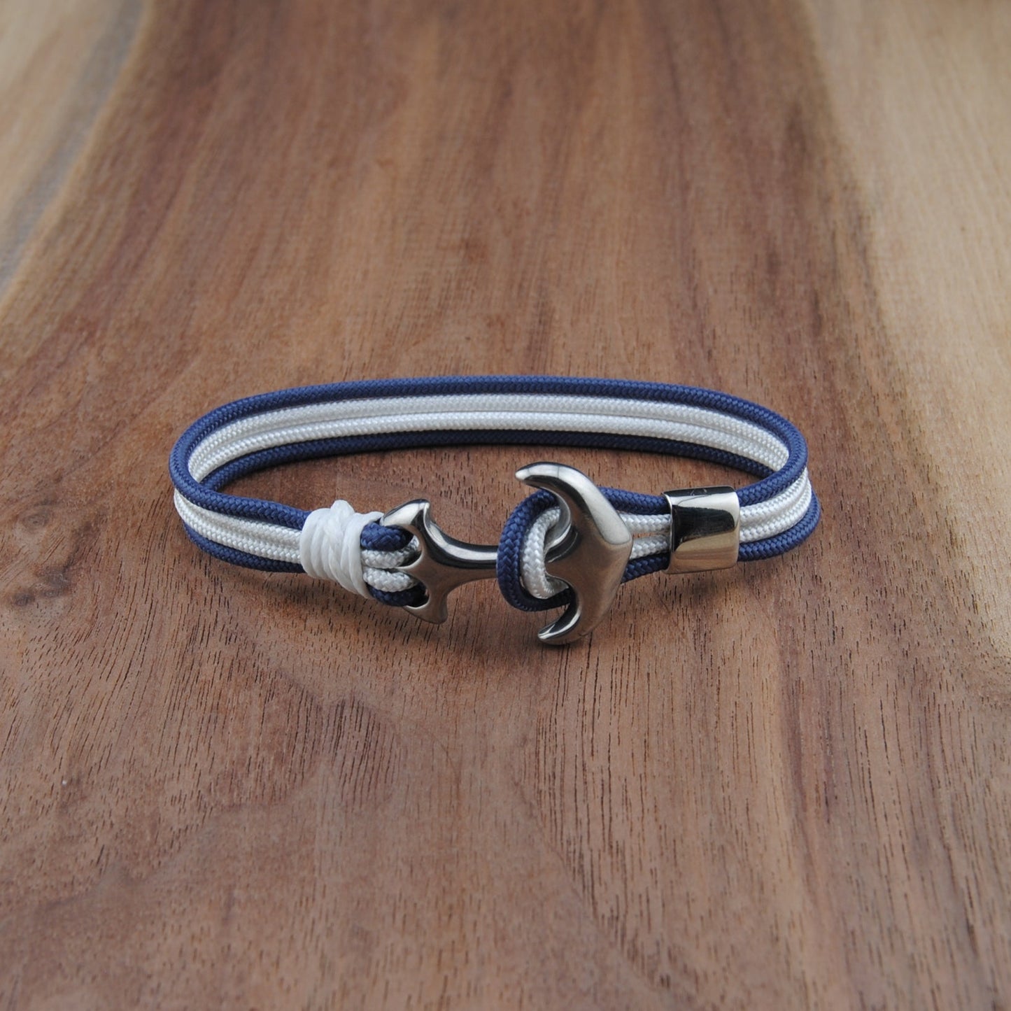 Bracelet with blue and white straps on a wooden surface