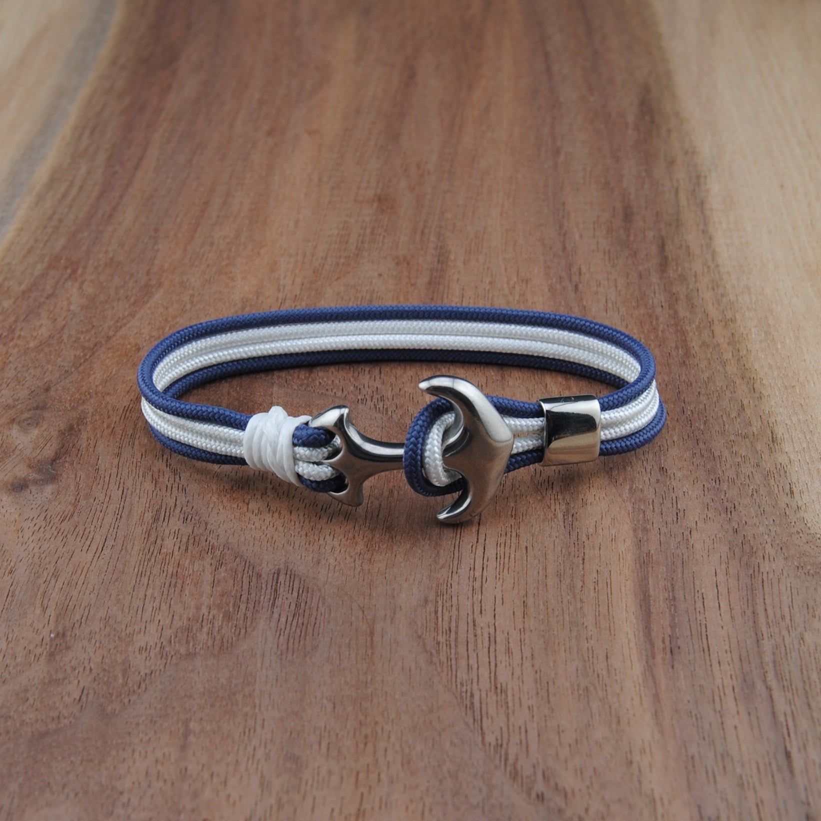 Bracelet with blue and white straps on a wooden surface