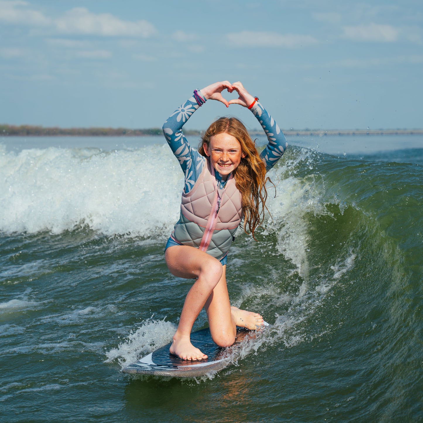 Person surfing on a wave with a clear sky background
