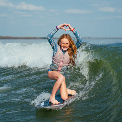 Person surfing on a wave with a clear sky background