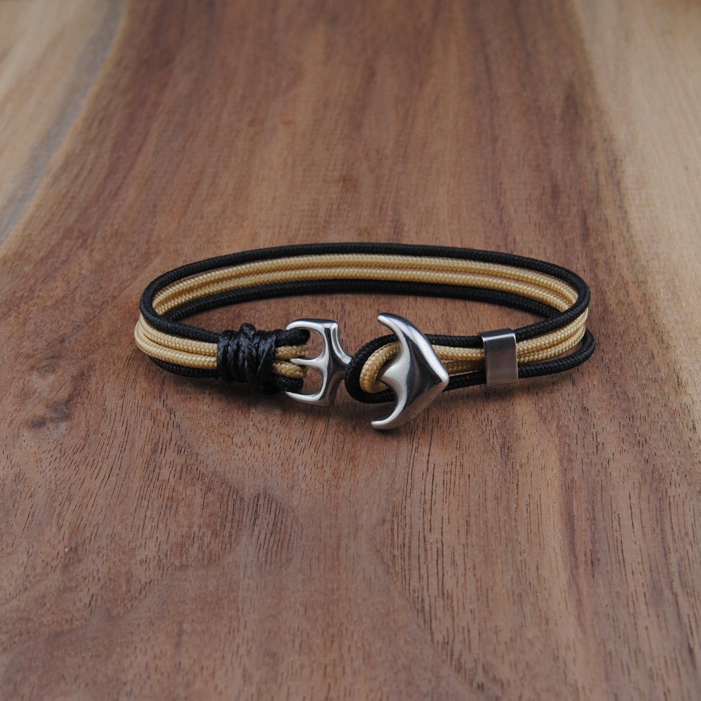 Bracelet with anchor charm on a wooden surface