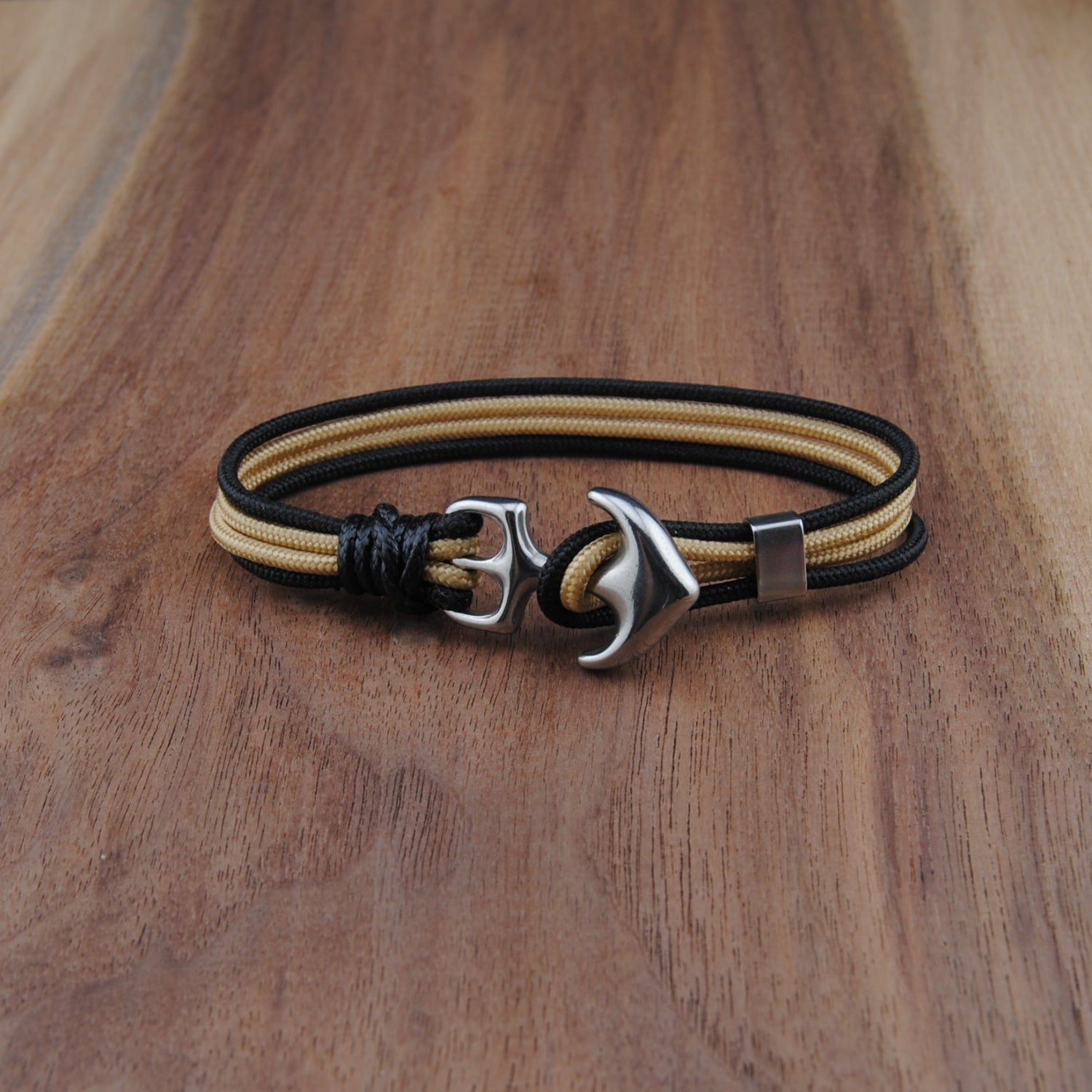 Bracelet with anchor charm on a wooden surface