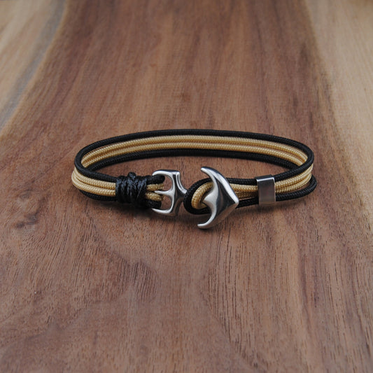 Bracelet with anchor charm on a wooden surface