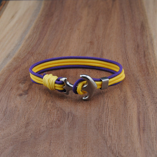 Yellow and purple bracelet with a metal clasp on a wooden surface
