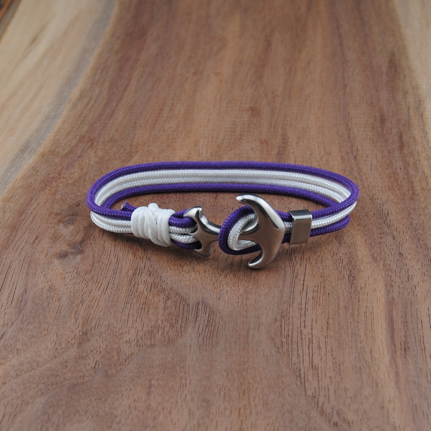 Bracelet with purple, white, and silver design on a wooden surface
