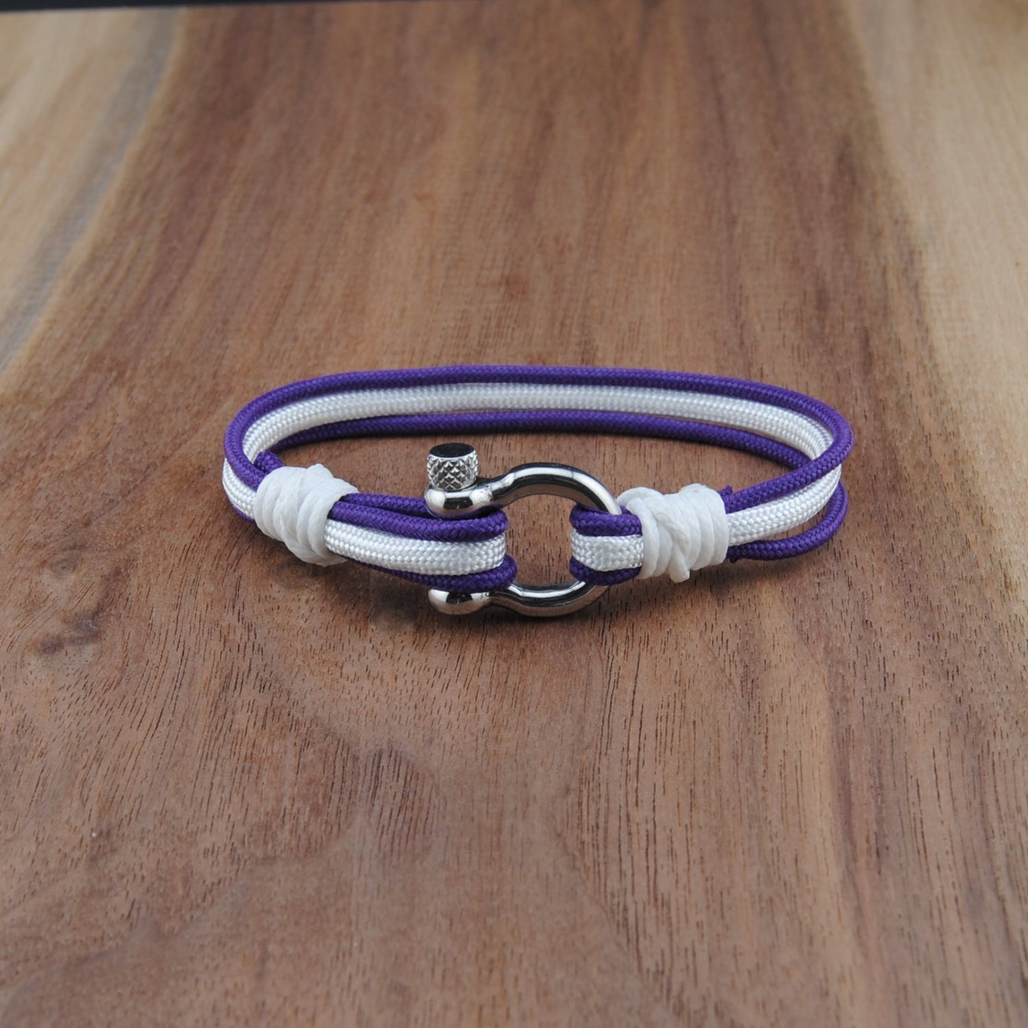 Purple and white bracelet on a wooden surface