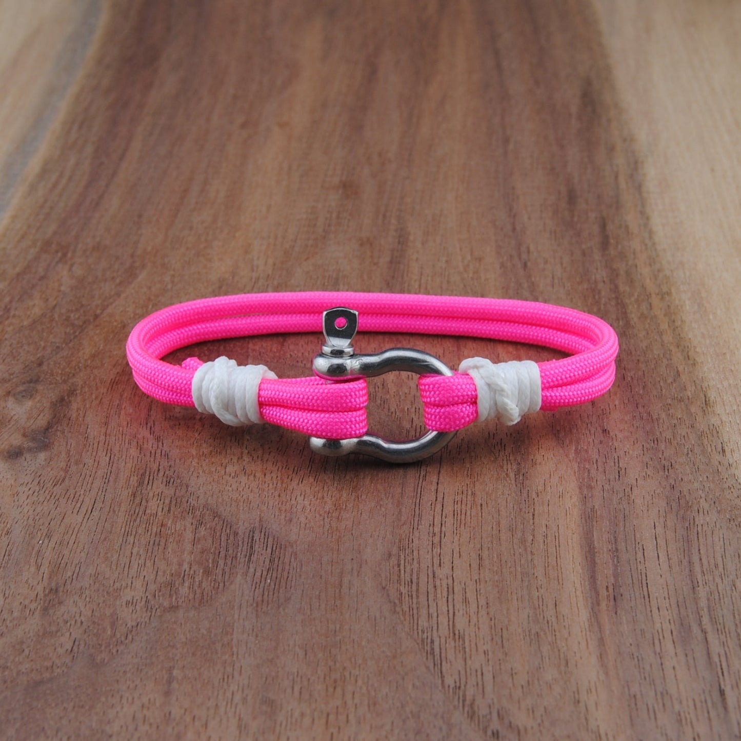 Pink  bracelet on a wooden surface