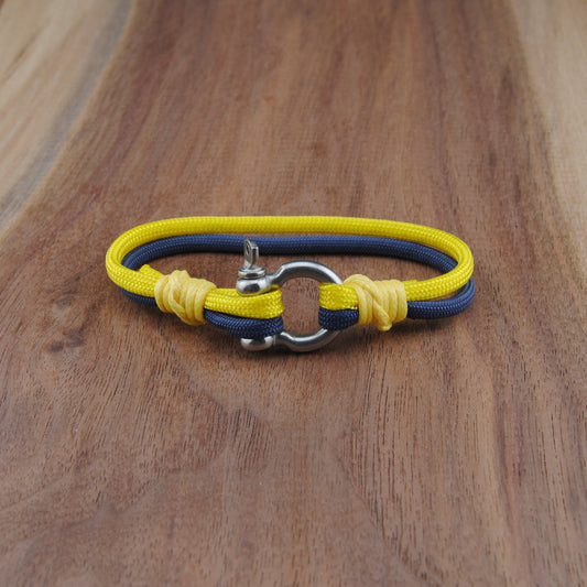 Yellow and blue bracelet with metal clasp on a wooden surface