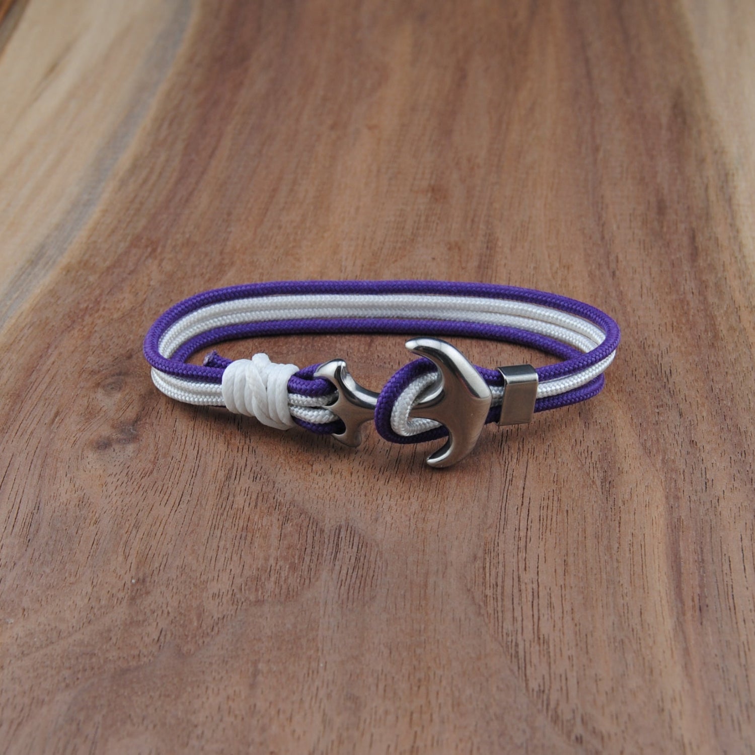 Bracelet with purple, white, and silver design on a wooden surface