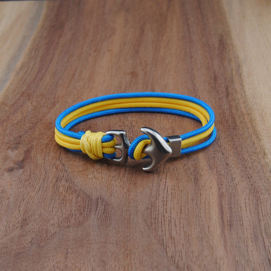 Yellow and blue bracelet with a silver clasp on a wooden surface