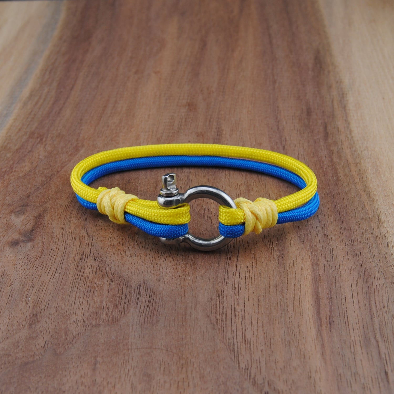 Yellow and blue bracelet on a wooden surface