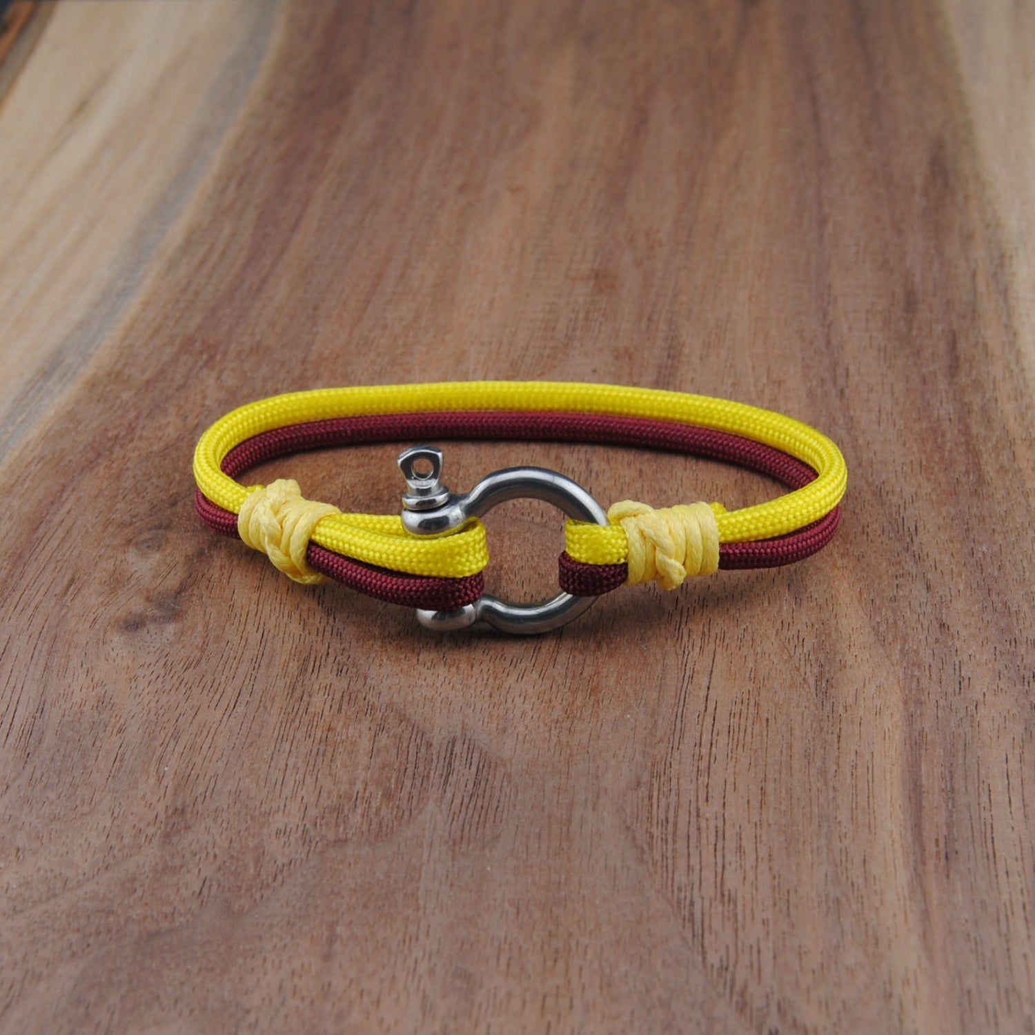 Yellow and red bracelet on a wooden surface