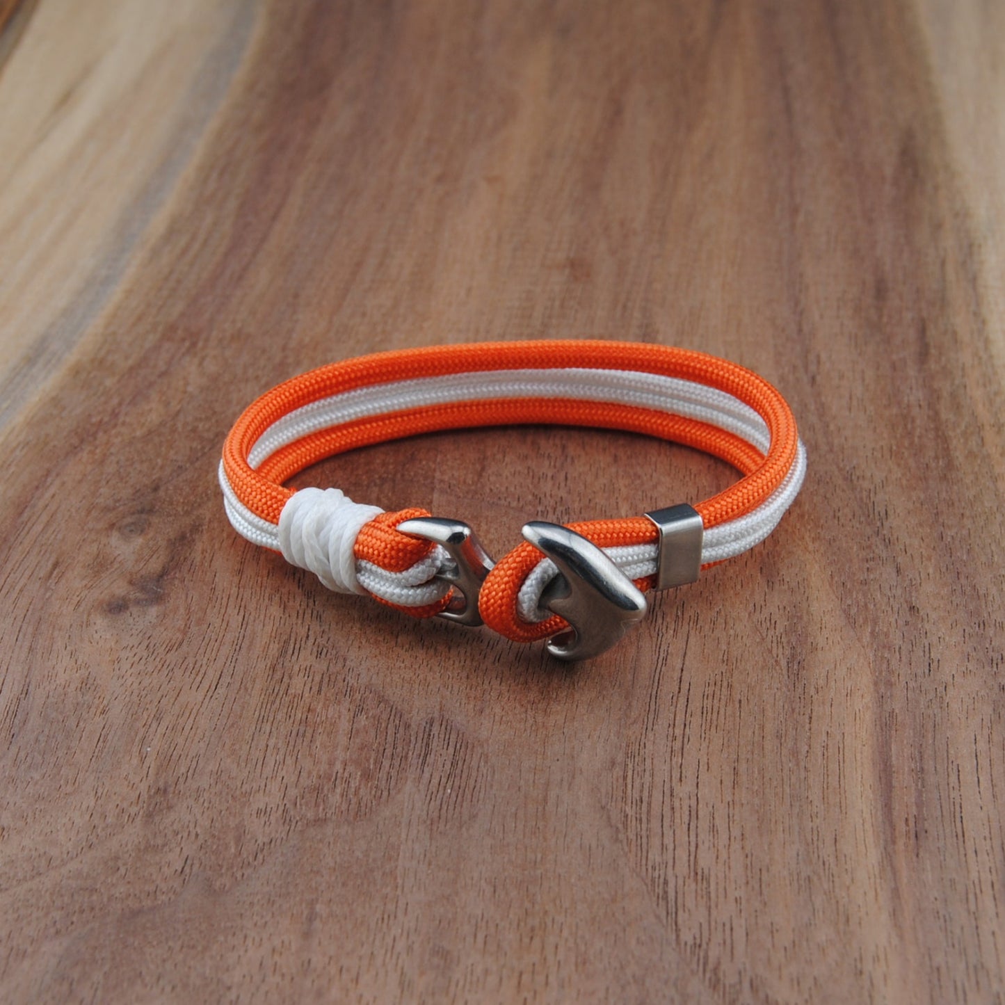 Orange and white bracelet on a wooden surface