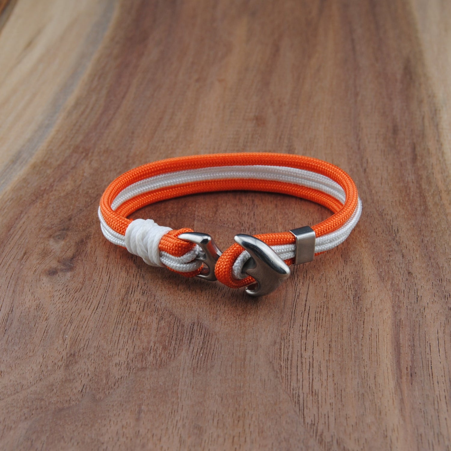 Orange and white bracelet on a wooden surface