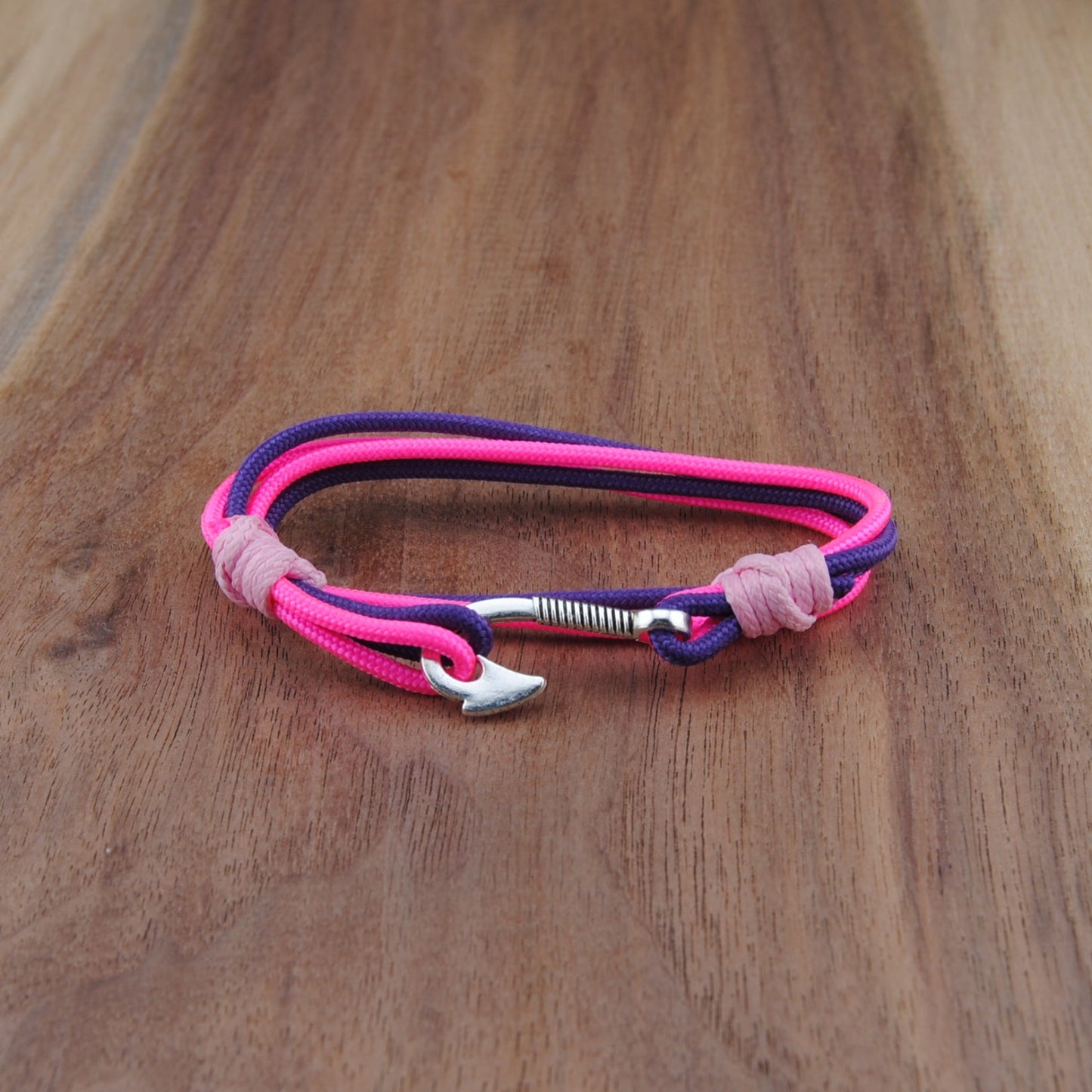 Pink and purple bracelet on a wooden surface