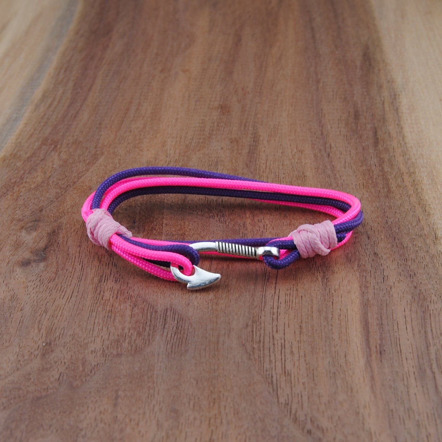 Pink and purple bracelet on a wooden surface