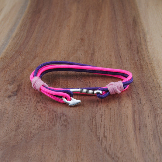 Pink and purple bracelet on a wooden surface