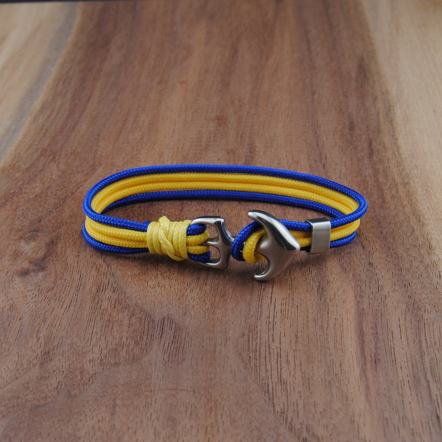 Blue and yellow Bracelet with metal clasp on a wooden surface