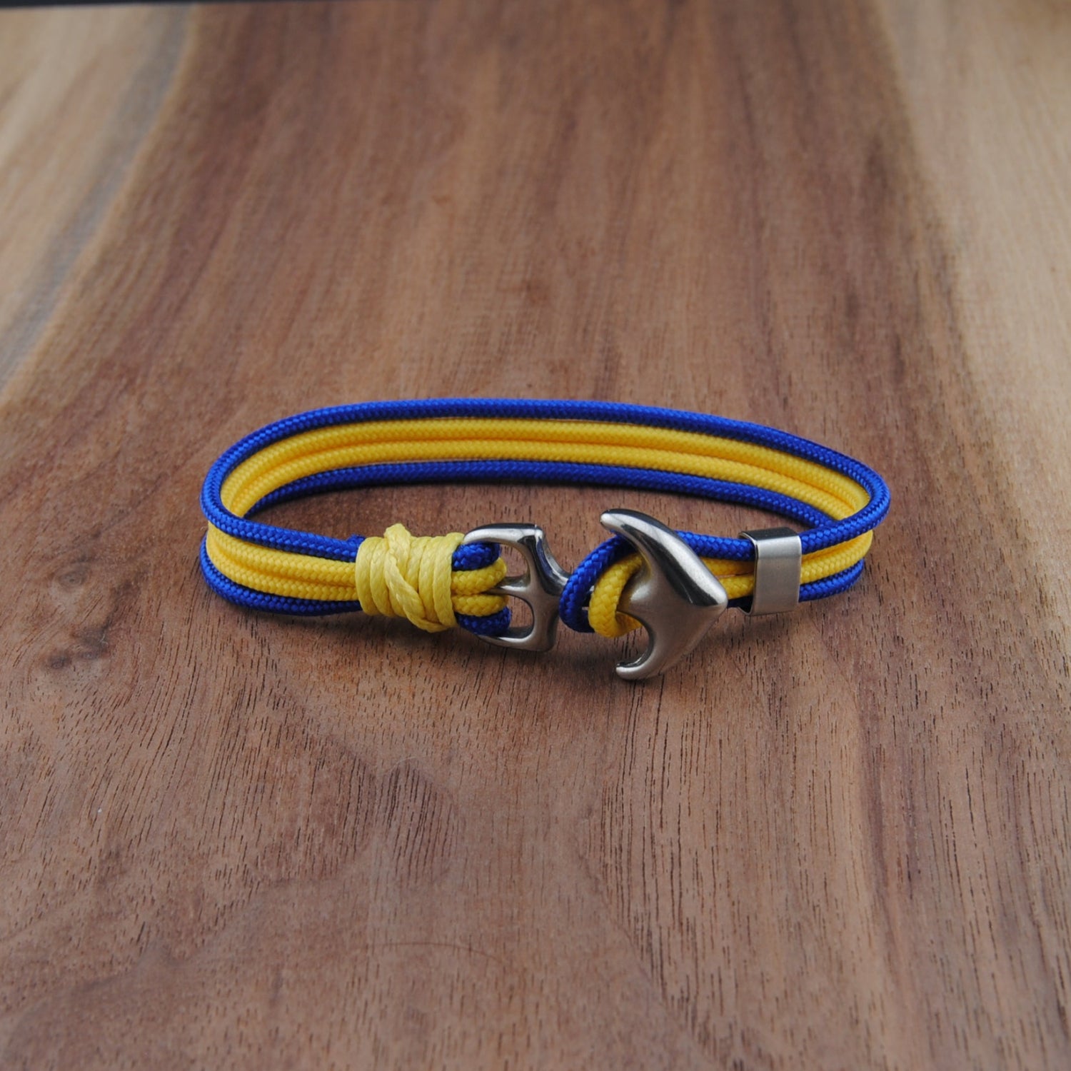 Blue and yellow Bracelet with metal clasp on a wooden surface