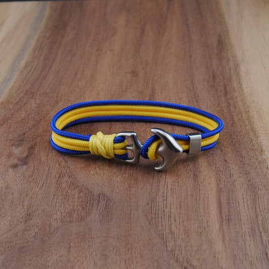 Blue and yellow Bracelet with metal clasp on a wooden surface
