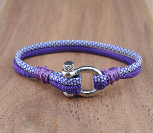 Purple and White bracelet with a metal clasp on a wooden surface
