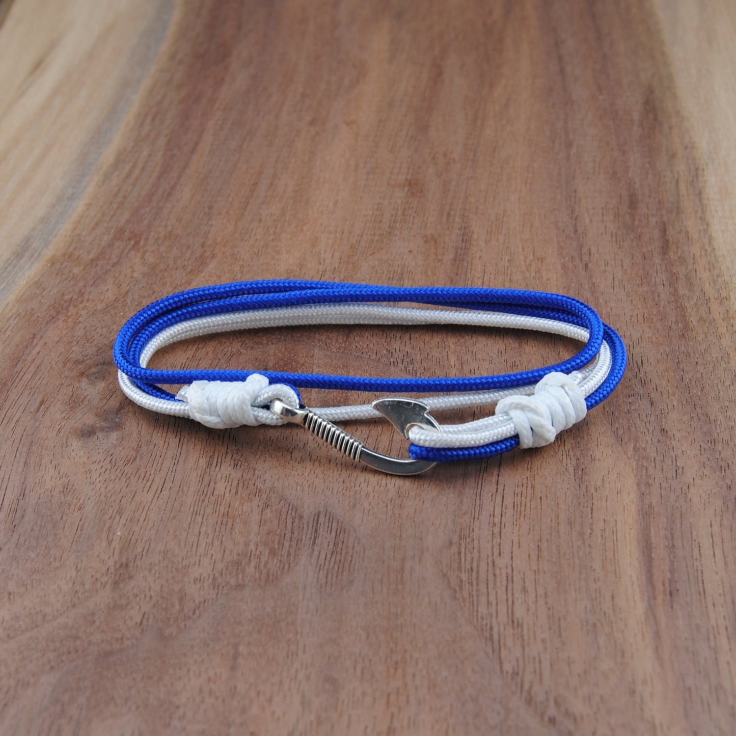Blue and white rope bracelet on a wooden surface