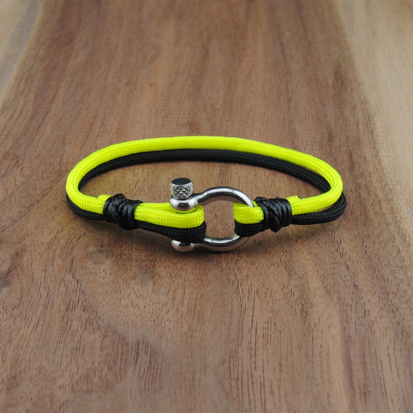 Neon yellow and black dog collar on a wooden surface