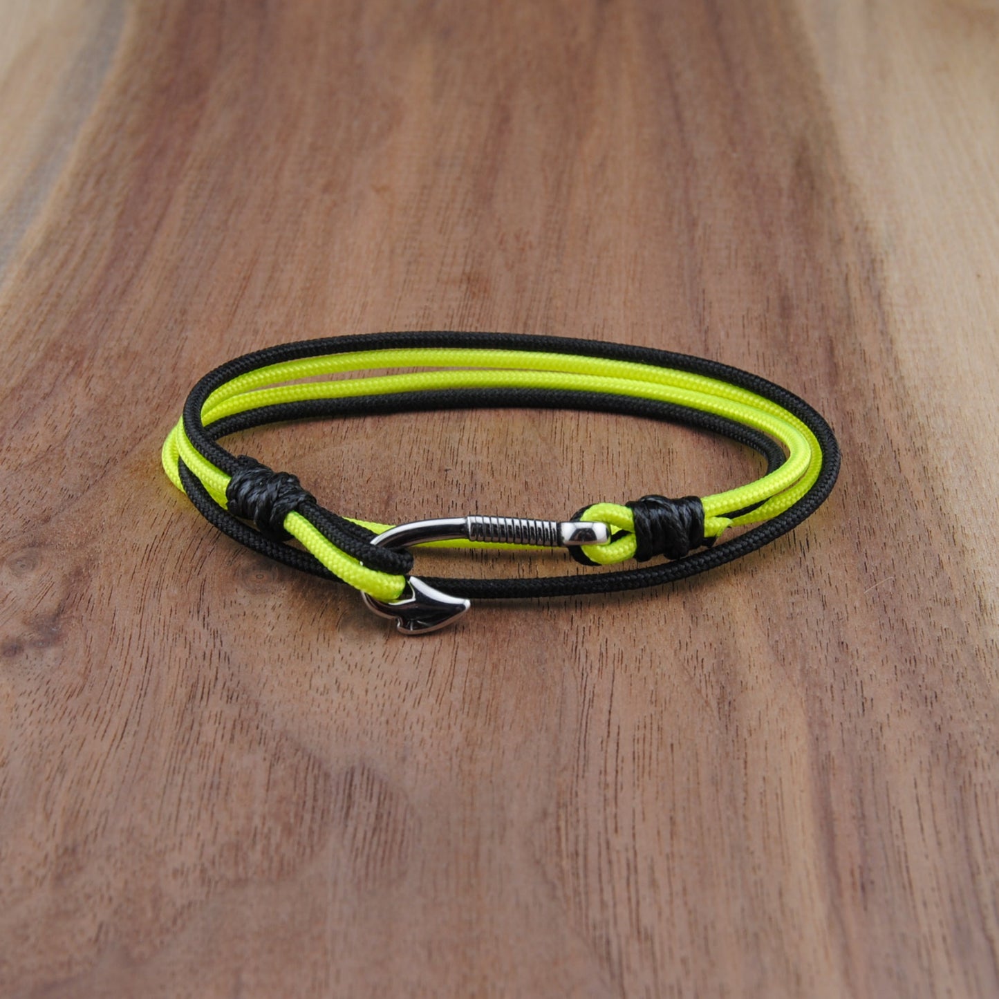 Neon yellow and black bracelet on a wooden surface