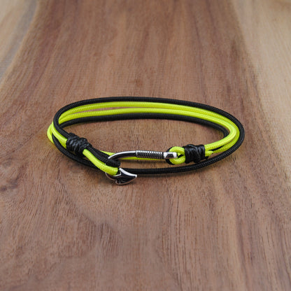 Neon yellow and black bracelet on a wooden surface