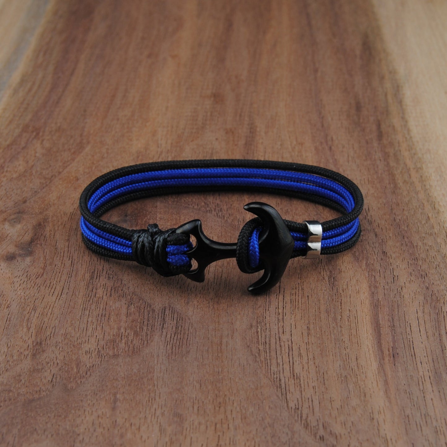Blue and black bracelet on a wooden surface