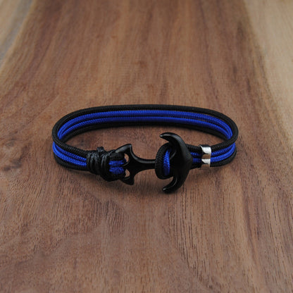 Blue and black bracelet on a wooden surface