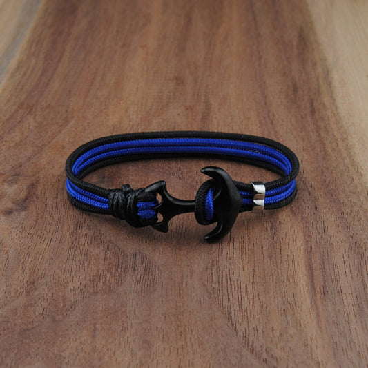 Blue and black bracelet on a wooden surface