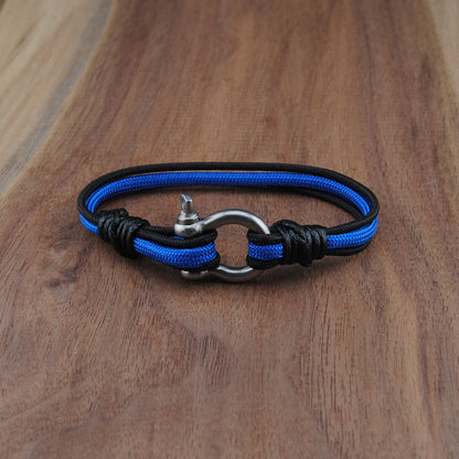Blue and black braided bracelet on a wooden surface