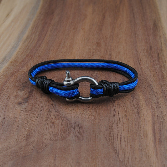 Blue and black braided bracelet on a wooden surface