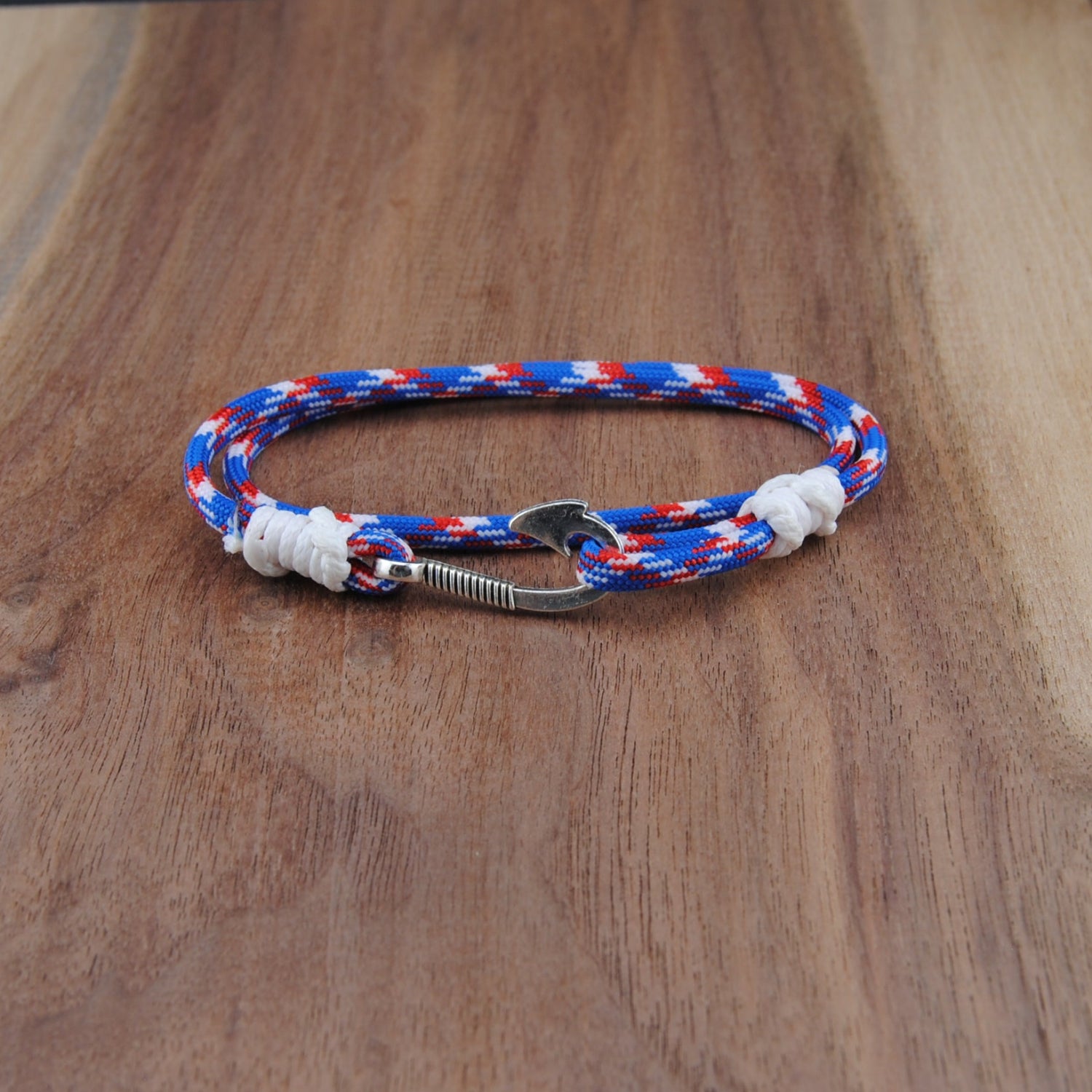 Bracelet with red, white, and blue pattern on a wooden surface