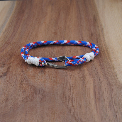 Bracelet with red, white, and blue pattern on a wooden surface