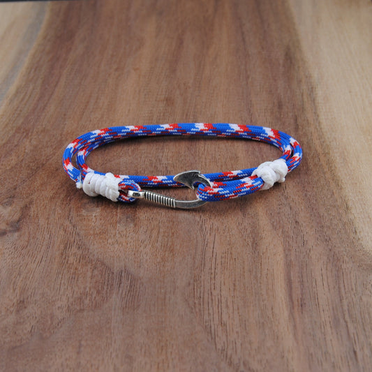 Bracelet with red, white, and blue pattern on a wooden surface